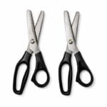Heavy duty pinking shears scissors with stainless steel zig zag blades and black ergonomic handles isolated on white background