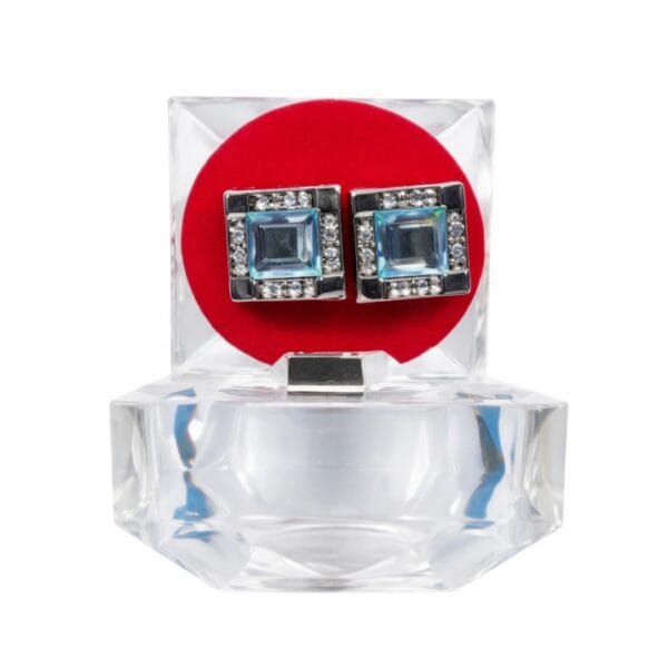 Men’s square blue crystal cufflinks with silver tone frame displayed in clear jewelry box isolated on white background