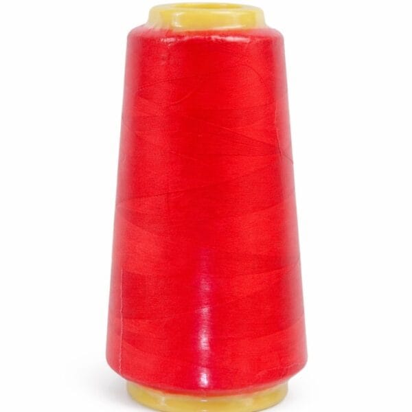 Red polyester sewing thread on yellow cone for industrial sewing and tailoring