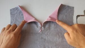 Invisible zip sewn into a dress neckline, demonstrating a clean concealed zipper installation for Aso-Ebi gowns and other Nigerian fashion garments.